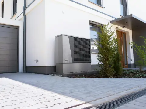 Heat pump installed beside a modern home